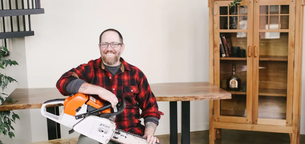 Tom Charters holding a chainsaw